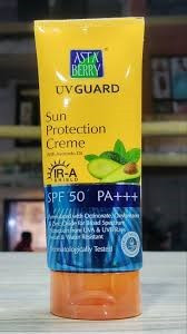Astaberry UV Guard Sun Protection Creme featuring a bright yellow and blue tube with an avocado graphic.