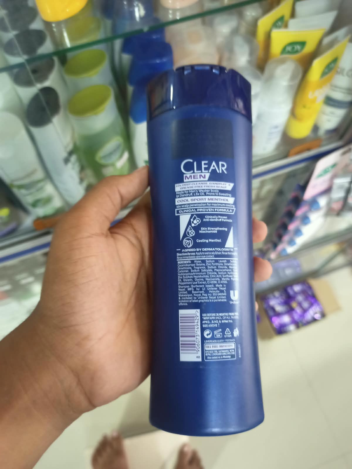 Clear Men Cool Sport Menthol Anti-Dandruff Shampoo featuring a mint leaf graphic and a price label.