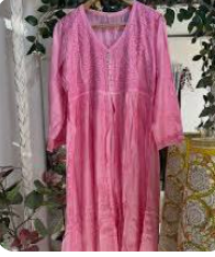 light pink long cotton dress featuring delicate embroidered patterns and a front button placket.