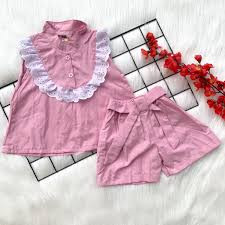 pink sleeveless children's two-piece outfit featuring a charming white lace-trimmed collar and matching shorts with an integrated bow belt