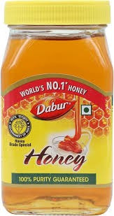 Dabur Honey with a yellow cap and a "Purity Guaranteed" label.