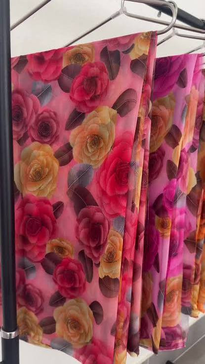 light peach floral-printed fabric featuring vibrant orange and magenta roses.