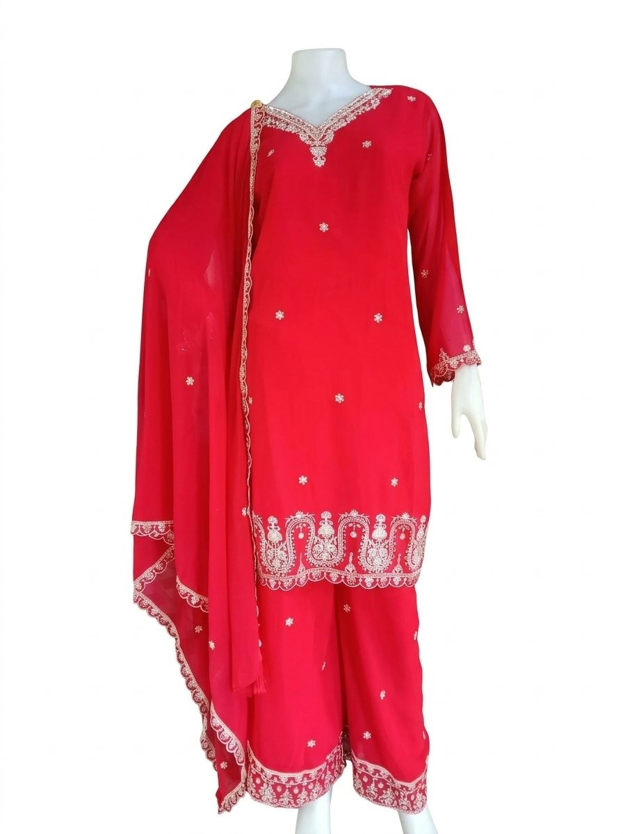 red ethnic kurta set featuring delicatwhite floral embroidery along the hem and neckline, paired with a matching dupatta.