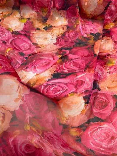 light peach floral-printed fabric featuring vibrant orange and magenta roses.