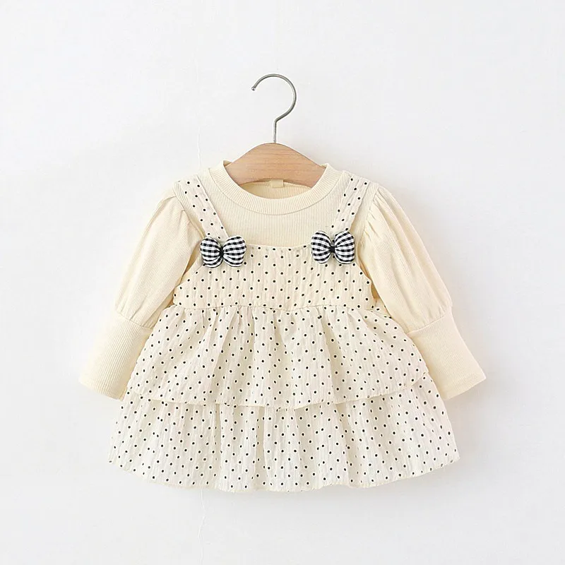 baby girl's long-sleeve polka dot dress featuring cute checkered bow accents on the layered suspender skirt